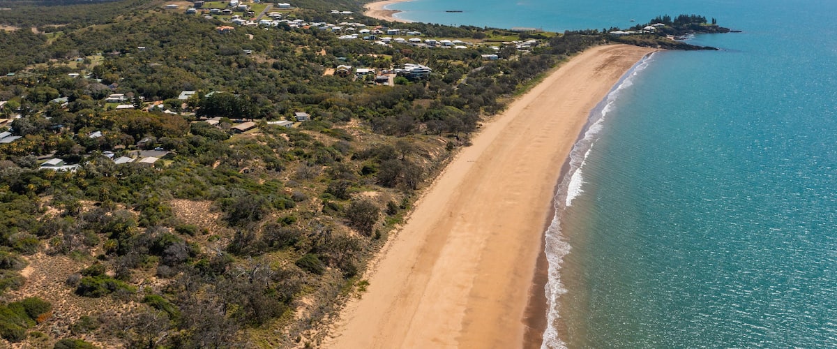 Emu Park Main Beach showing general coastal views, a beach and a coastal town