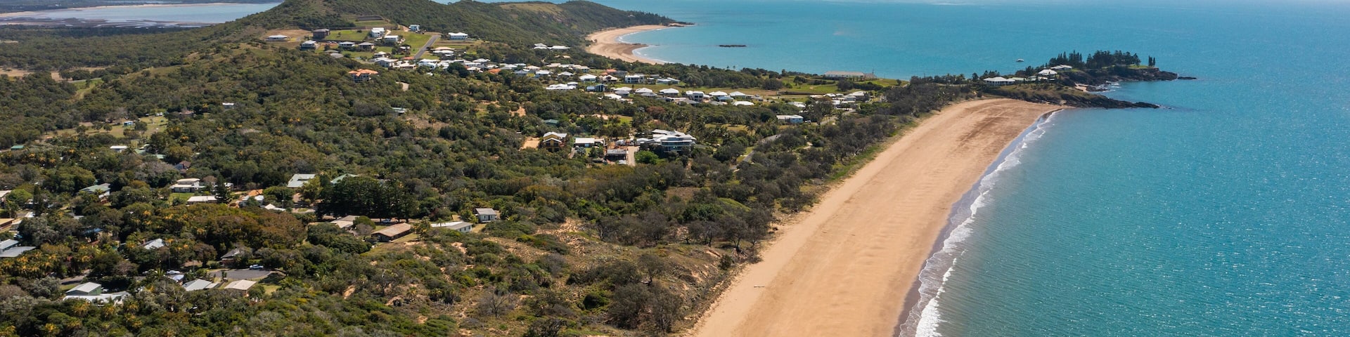 Emu Park Main Beach showing general coastal views, a beach and a coastal town