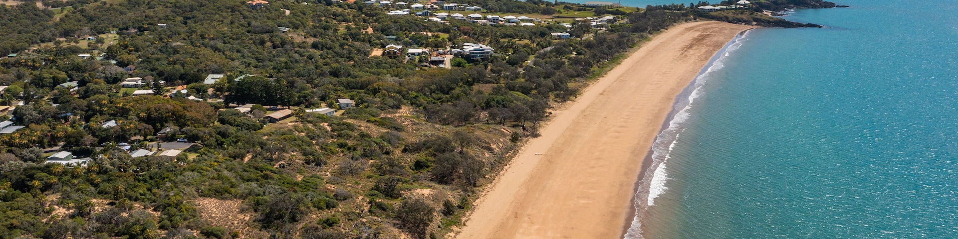 Emu Park Main Beach showing general coastal views, a beach and a coastal town