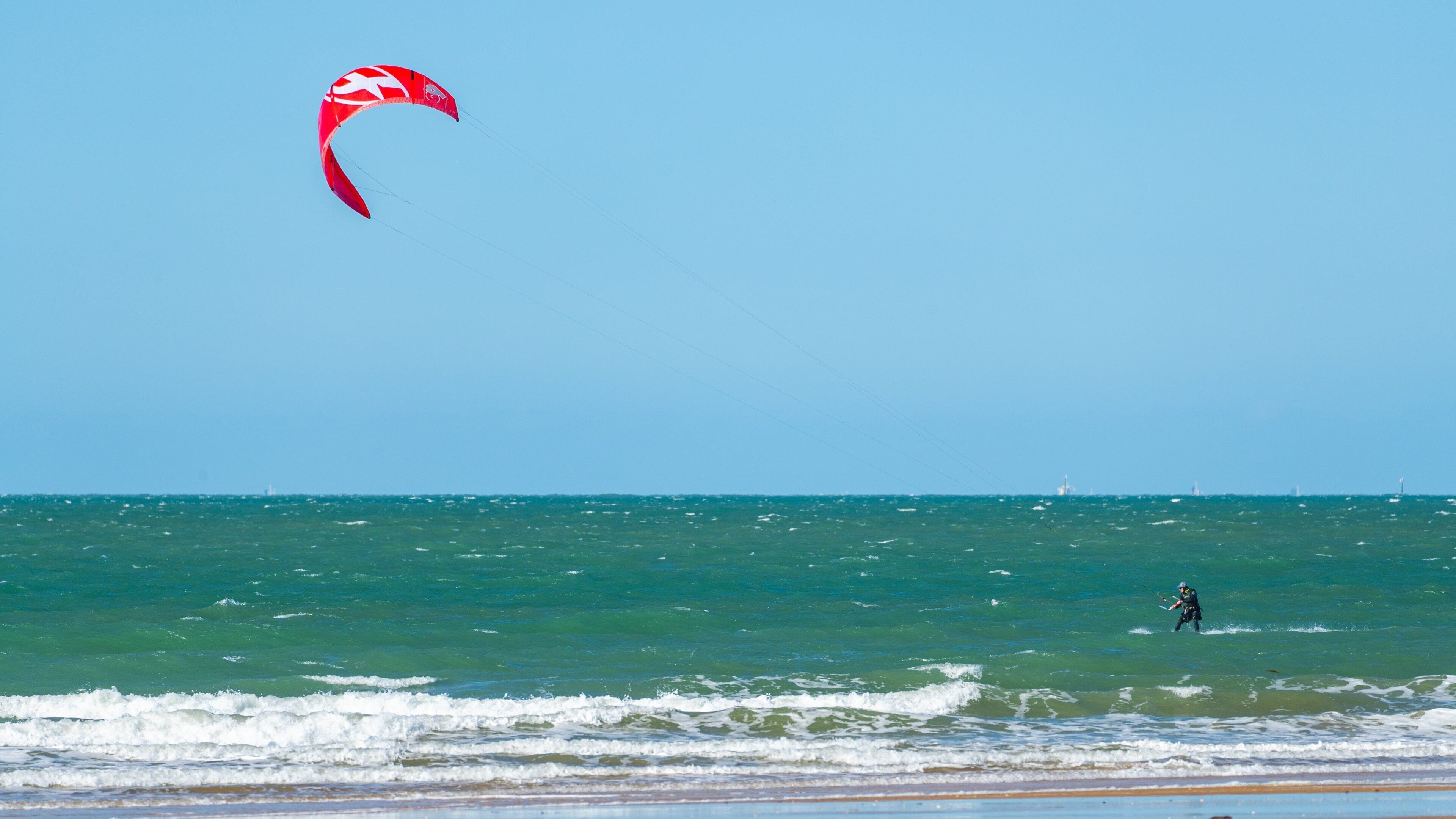 Tannum Sands Beach featuring kite surfing and general coastal views as well as an individual male
