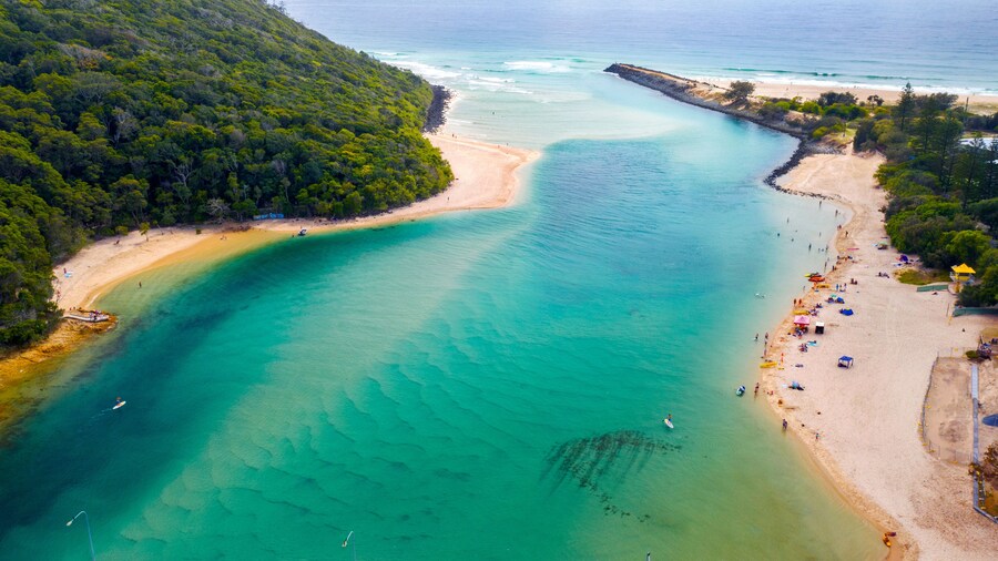 Aerial view over Tallebudgera creek Gold Coast, with swimmers on the beach