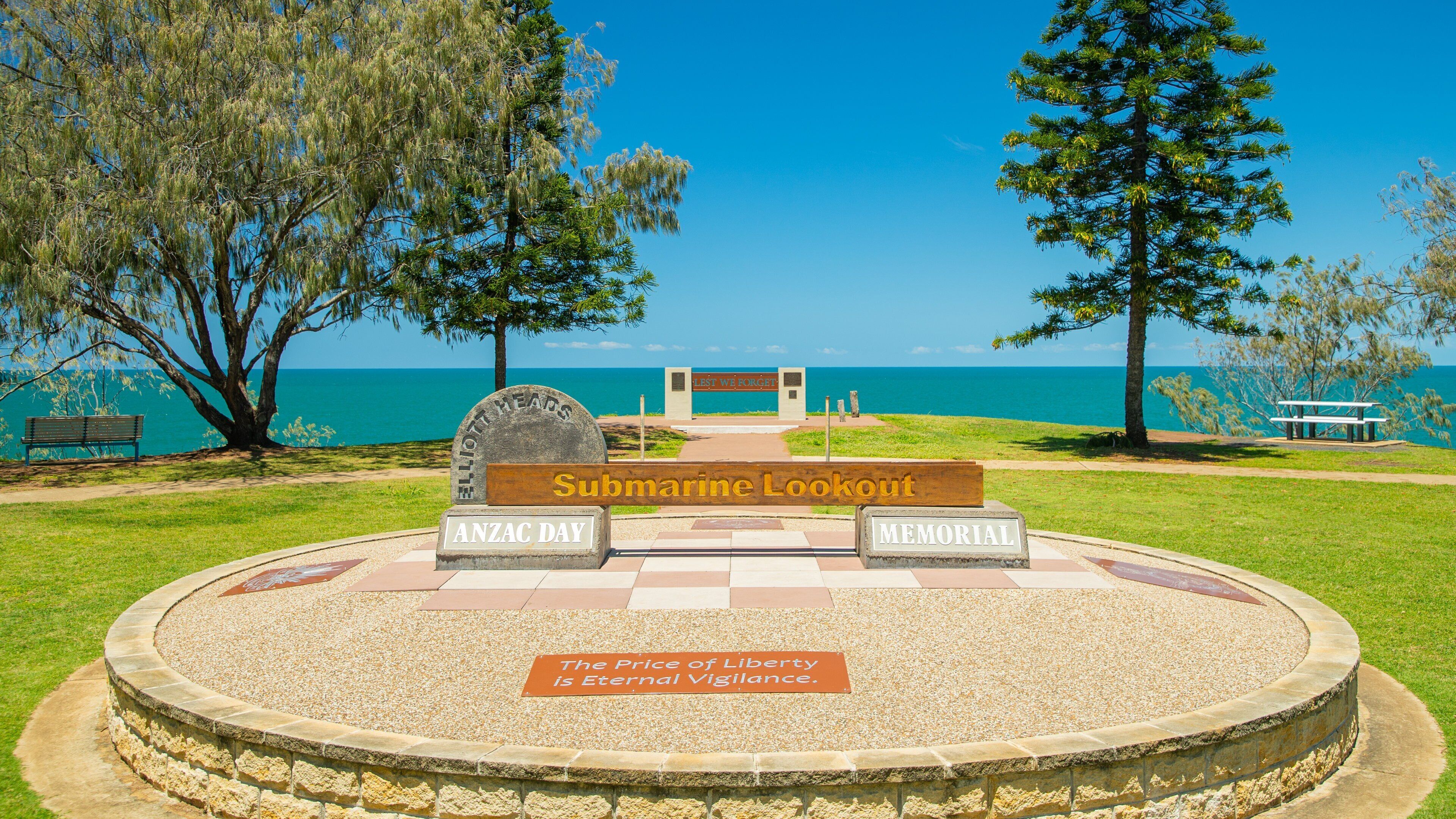 Elliot Heads Beach which includes signage and general coastal views