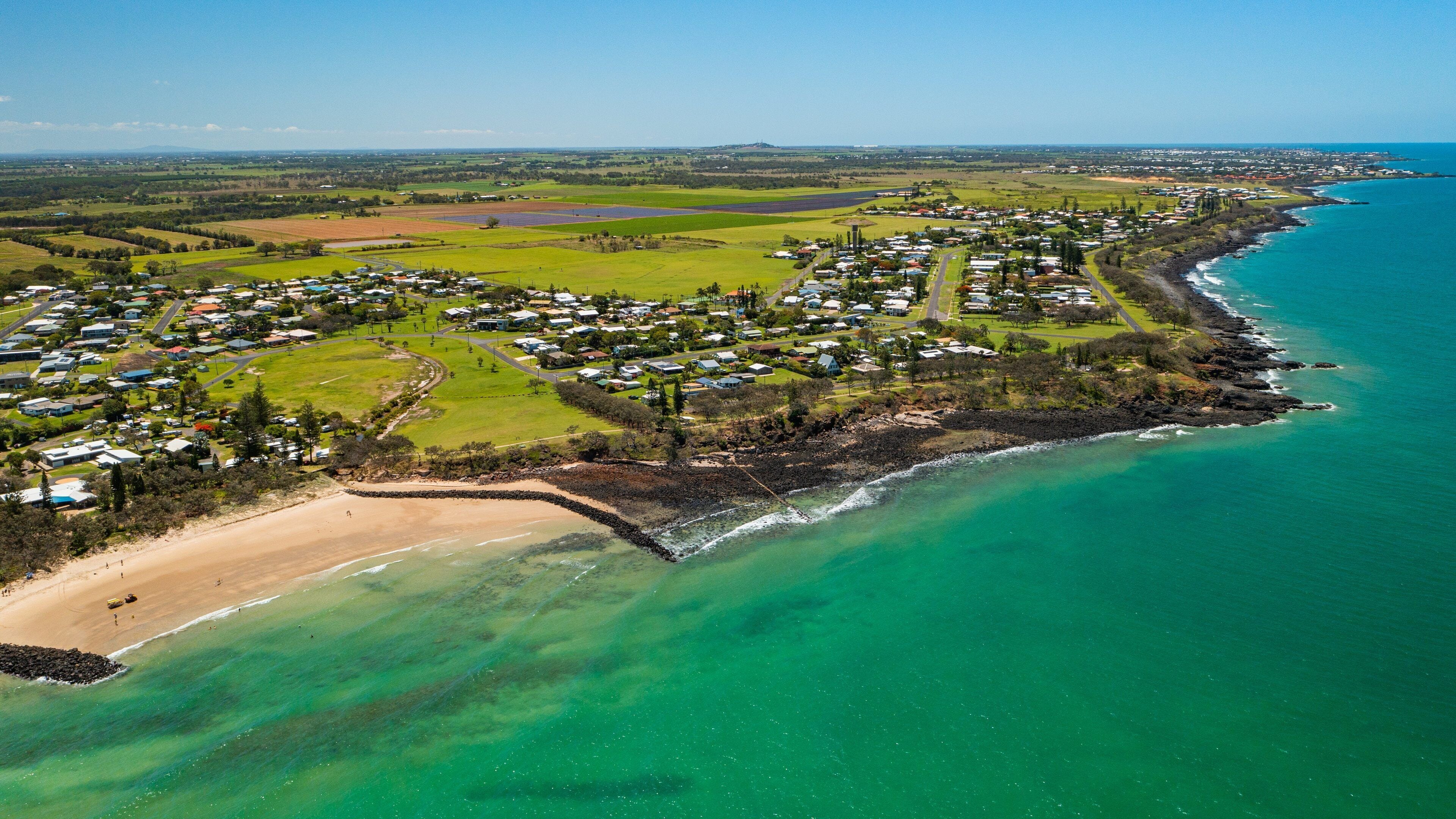 Elliot Heads Beach which includes a coastal town, general coastal views and landscape views