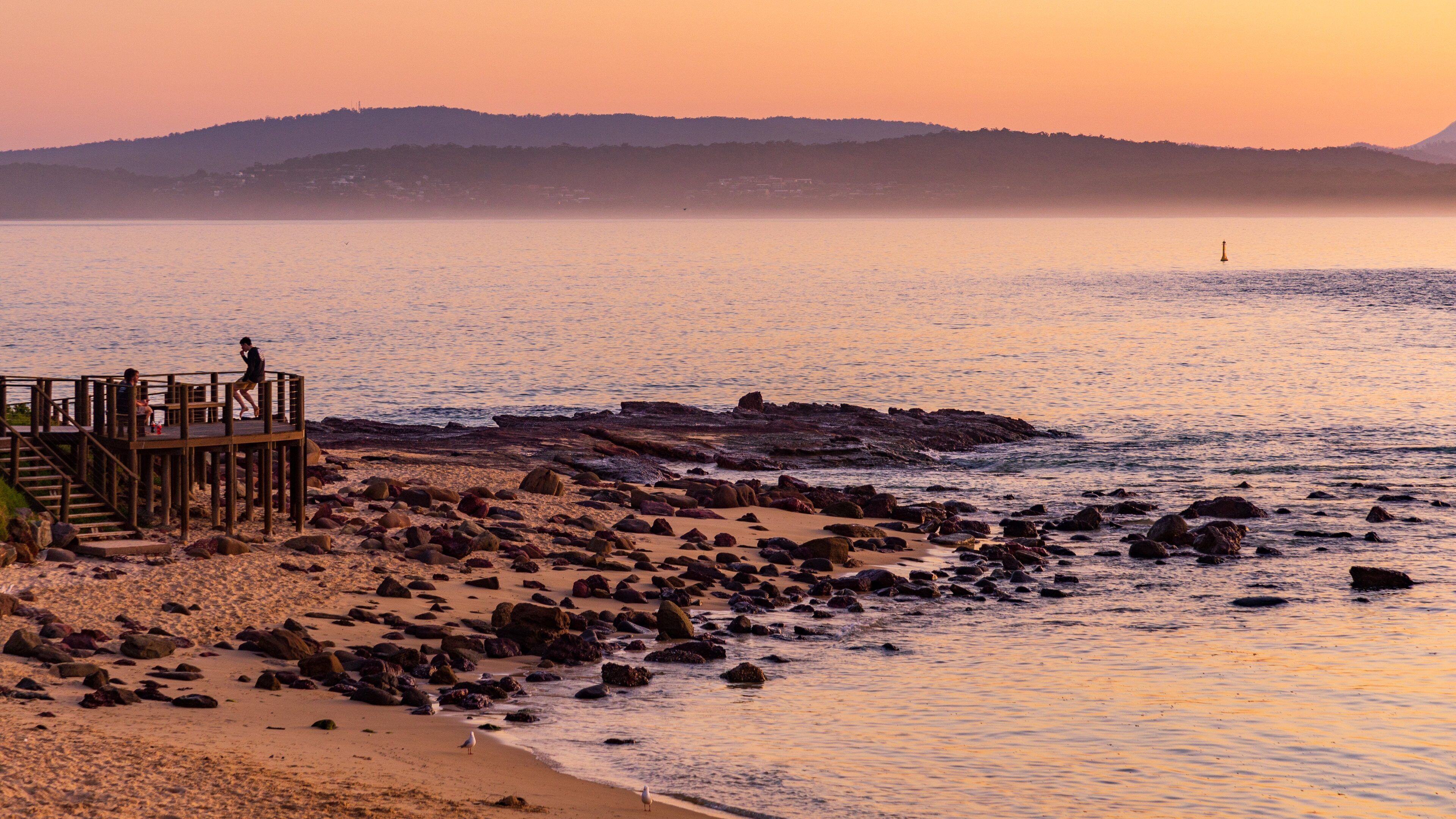 Bar Beach which includes a sunset and general coastal views