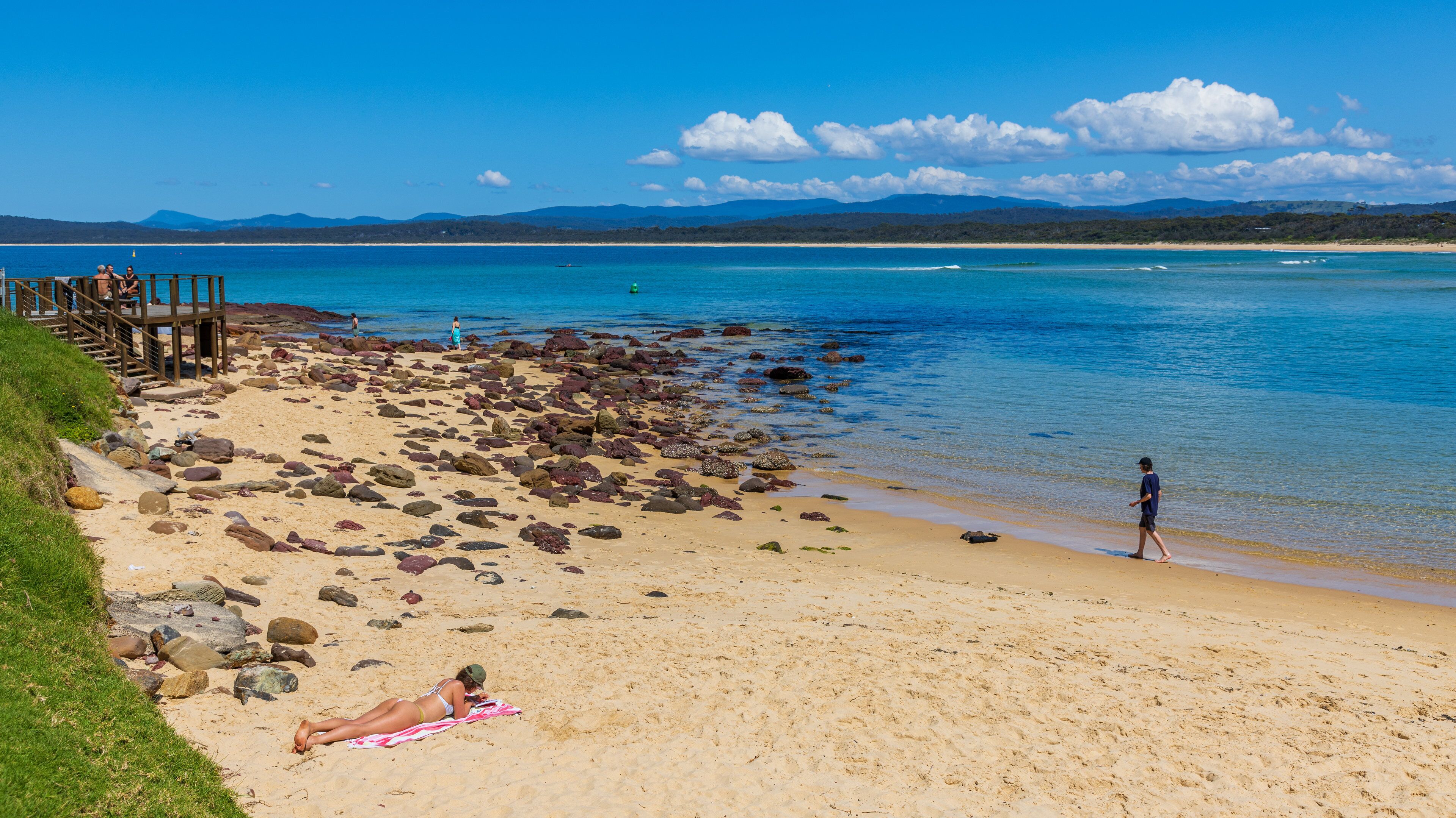 Bar Beach showing general coastal views and a sandy beach as well as an individual femail