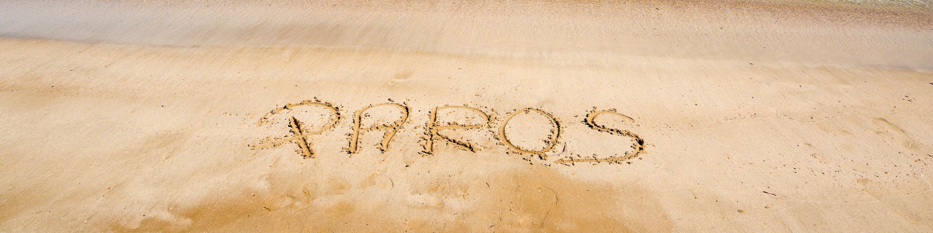 Santa Maria beach with golden sand, emerald waters and view on the island of Naxos. The best beach of Paros. Cyclades, Greece