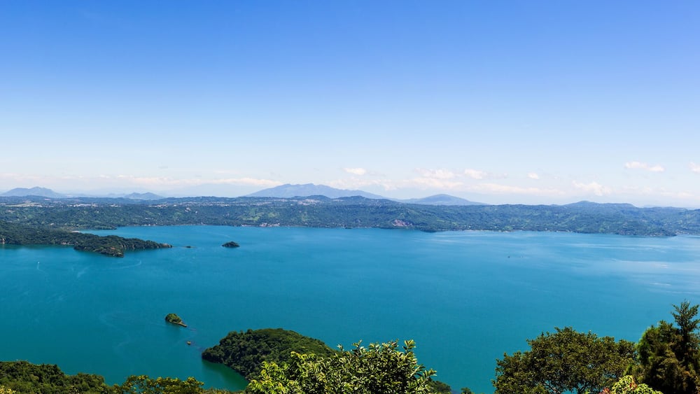 Panoramic Landscape of Lake Surrounded by Lush Green Forest and Mountains. Ilopango Lake, El SAlvador