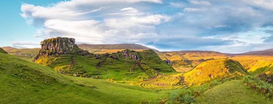 Panorama of famous mystic Fairy Glen at sunset, a green valley with romantic landscapes. Copy space in sky.