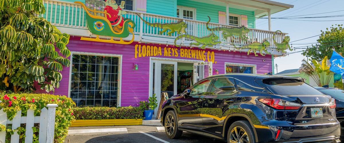 A colorful building with a sign reading "Florida Keys Brewing Co." and a Santa Claus decoration.