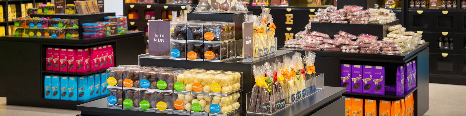 A chocolate shop with various chocolate products displayed on shelves and counters.