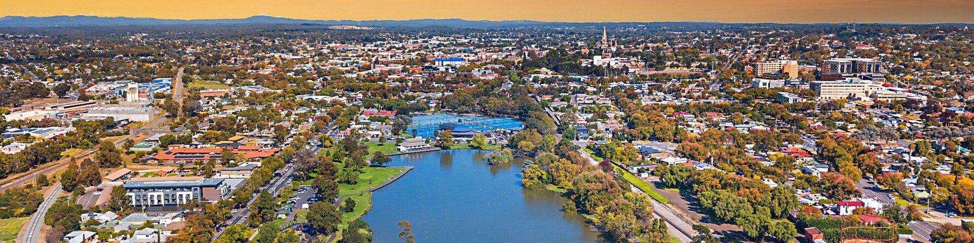 Lake Weeroona Bendigo panoramic view. Sunrise sunset morning evening flight with spectacular landscape and cityscape views. Red purple and blue skies. Central Victoria Australia.