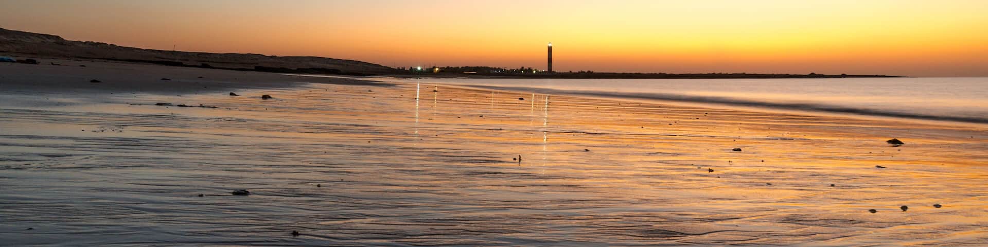 Dusk shot at Shivrajpur beach gujarat India with cloudy sky and reflection in waves