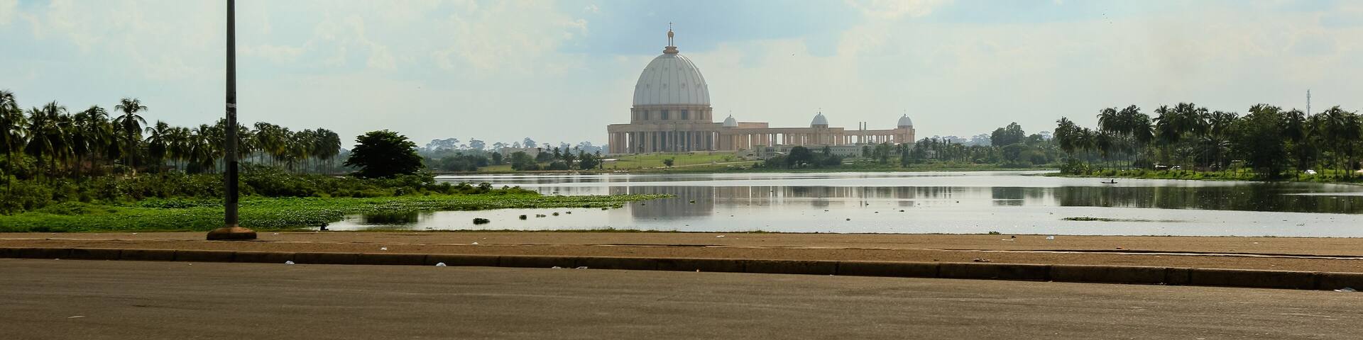 Stunning view of Basilica of Our Lady of Peace reflecting in lake Yamoussoukro Ivory Coast