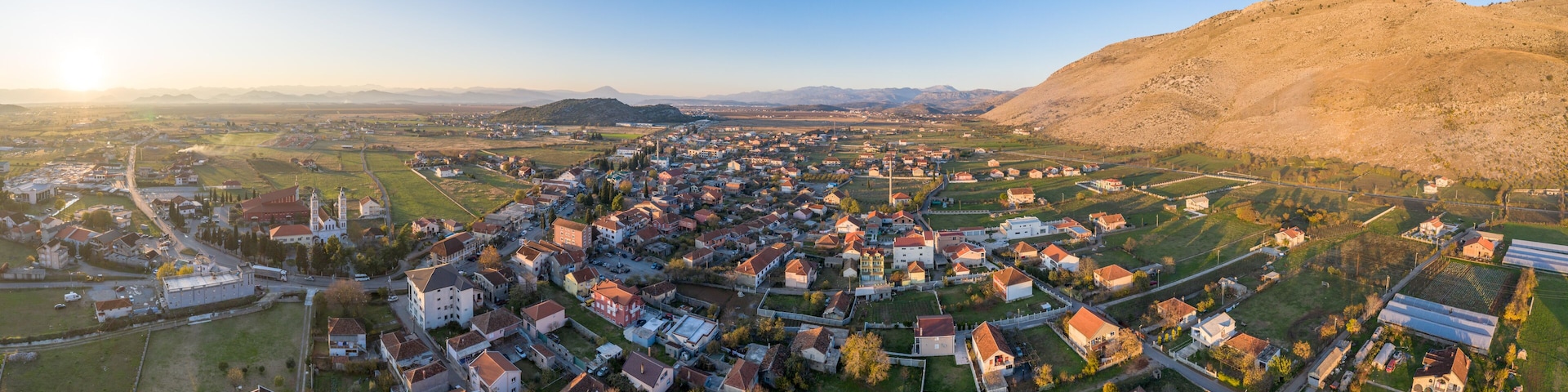 Tuzi, the youngest municipality in Montenegro, in the afternoon, close to sunset. Center of Malesi e Madhe District, populated mainly by Malisors. Situated at the foot of Decic hill. Aerial shot.