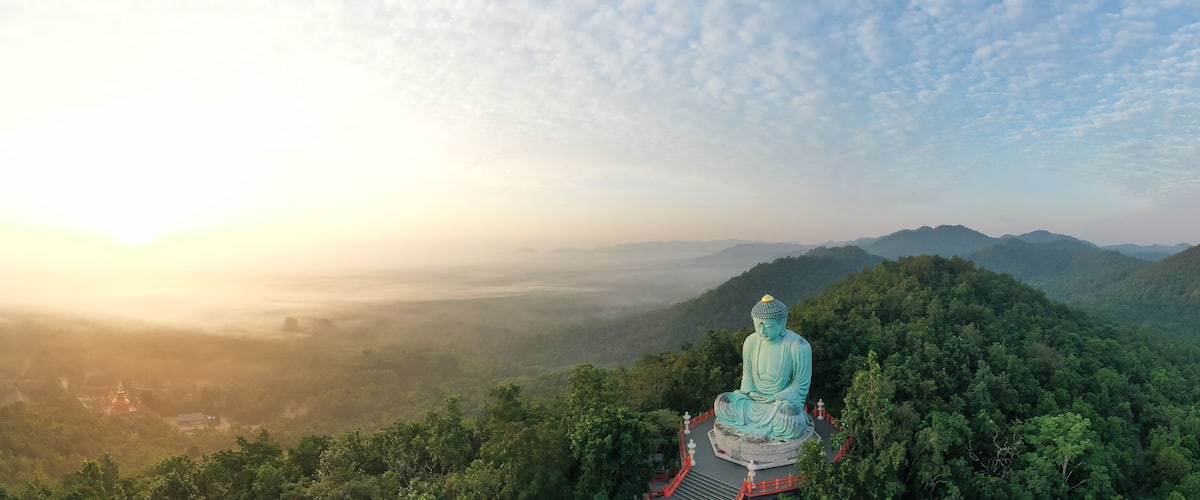 Aerial view of The Great Buddha at Doi Phra Chan is a towering bronze Buddha statue that can be reached by climbing 628 steps up at wat Prathat Doi Prachan, Pa Tan, Mae Tha District, Lampang, Thailand