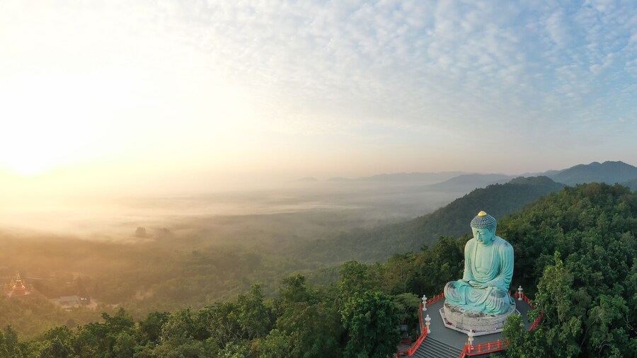 Aerial view of The Great Buddha at Doi Phra Chan is a towering bronze Buddha statue that can be reached by climbing 628 steps up at wat Prathat Doi Prachan, Pa Tan, Mae Tha District, Lampang, Thailand