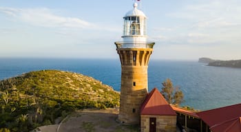 Hill top of Barrenjoey head of Sydney Pacific coast with the lighthouse overlooking palm beach on a sunny day.