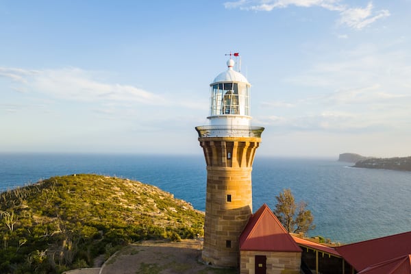 Hill top of Barrenjoey head of Sydney Pacific coast with the lighthouse overlooking palm beach on a sunny day.