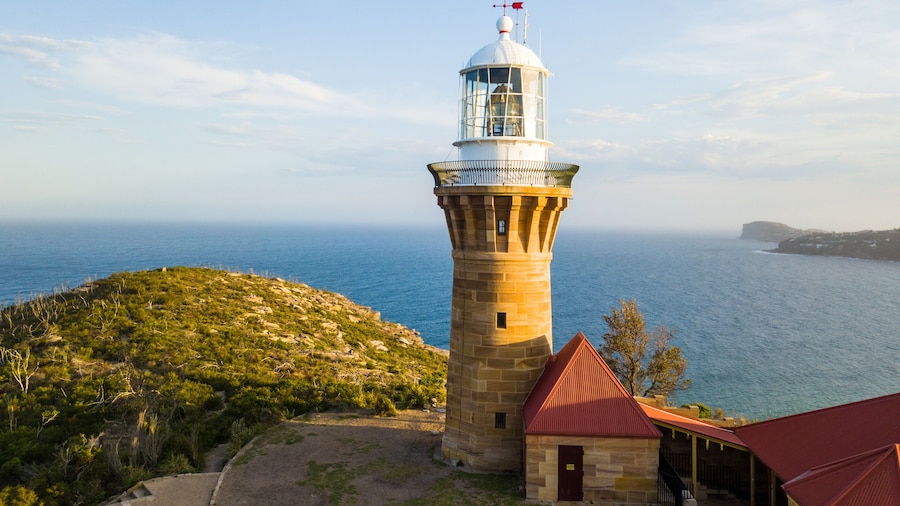 Hill top of Barrenjoey head of Sydney Pacific coast with the lighthouse overlooking palm beach on a sunny day.