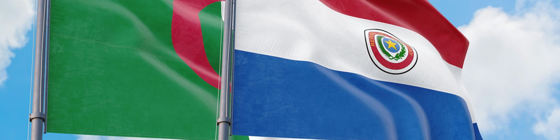 Paraguay and Algeria flags waving in the wind against white cloudy blue sky together. Diplomacy concept, international relations.