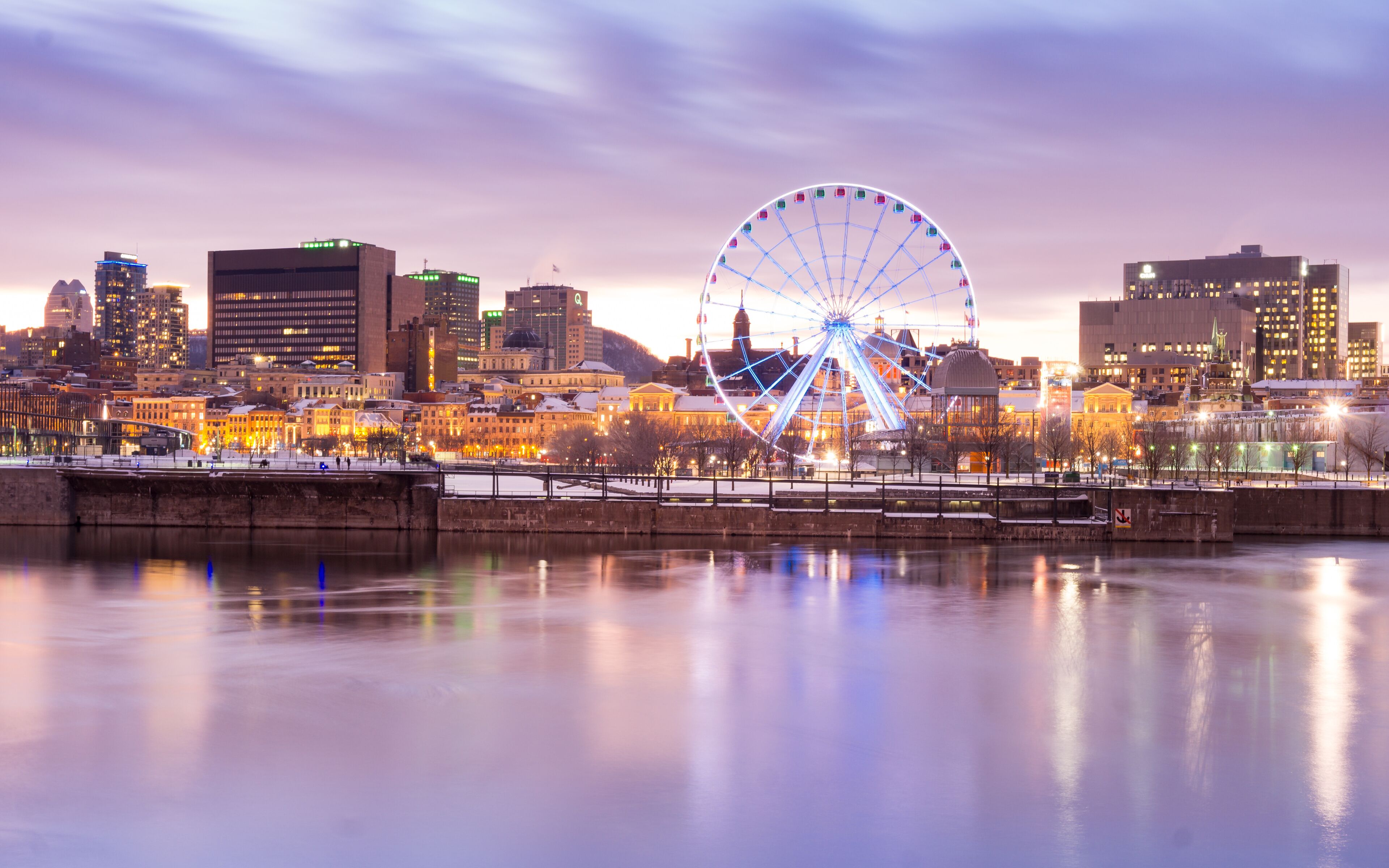 Sunset in winter over Montreal old port and ferris wheel in Quebec