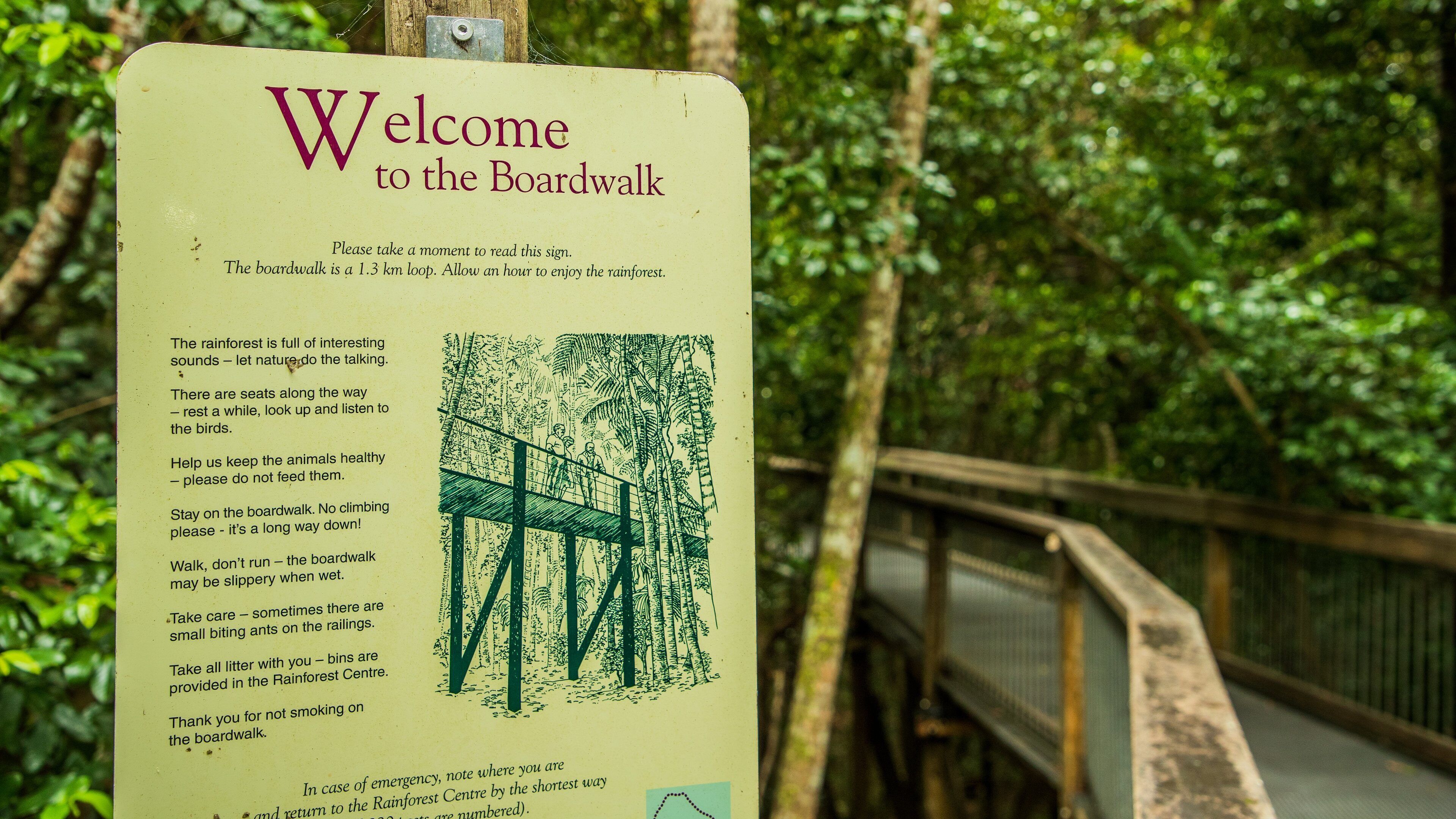 Sea Acres National Park featuring forests and signage