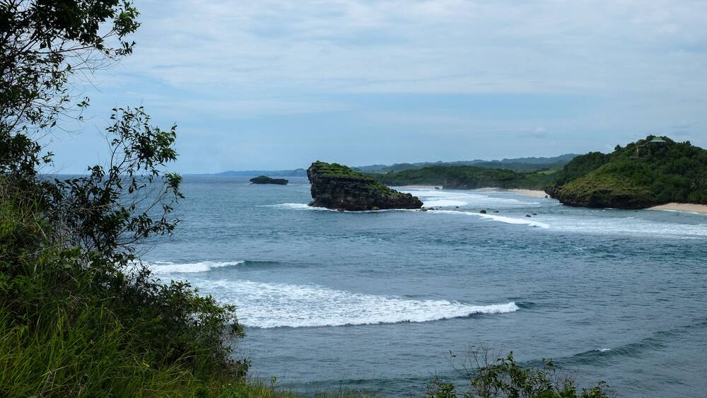 perfect destination for vacation - tropical bay with green rocks and small islands close to the shore close to Pacitan