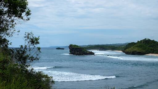 perfect destination for vacation - tropical bay with green rocks and small islands close to the shore close to Pacitan