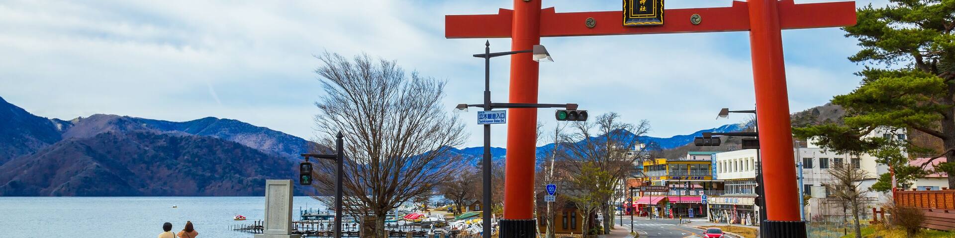 Massive torii gate of Futarasan shrine in front of lake Chuzenji in Nikko, Japan
