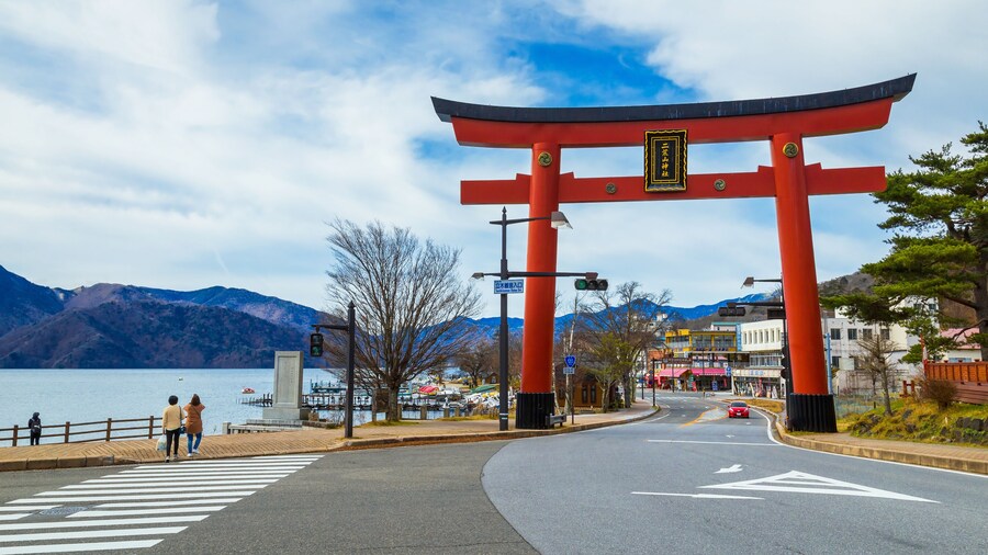 Massive torii gate of Futarasan shrine in front of lake Chuzenji in Nikko, Japan