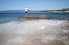 Urla, Izmir, Turkey; A child is fishing on the Altınköy cliffs, there is a flurry of movement due to the long exposure. 11 July 2020