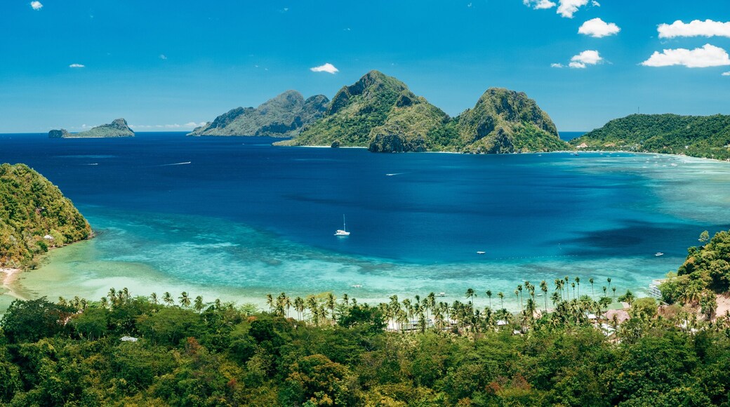 Aerial panoramic view of Las Cabanas beach and sea bay in El Nido, Palawan, Philippines
