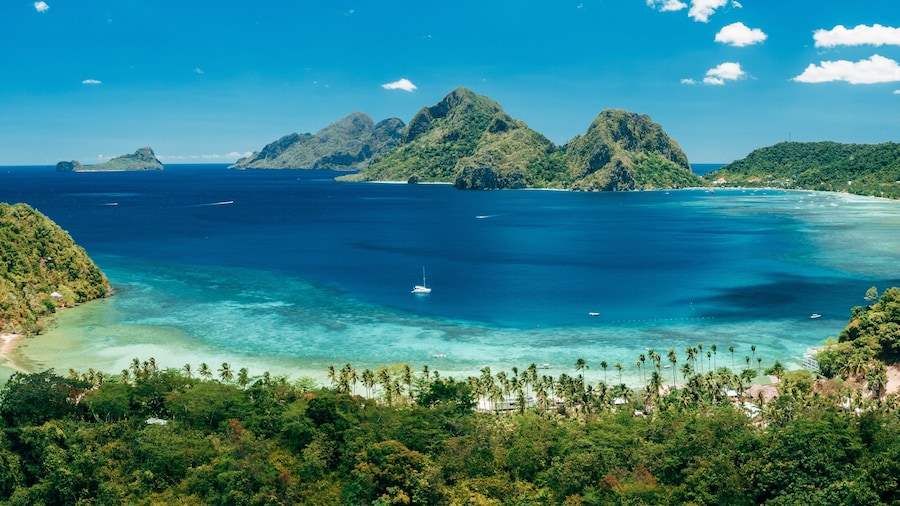 Aerial panoramic view of Las Cabanas beach and sea bay in El Nido, Palawan, Philippines