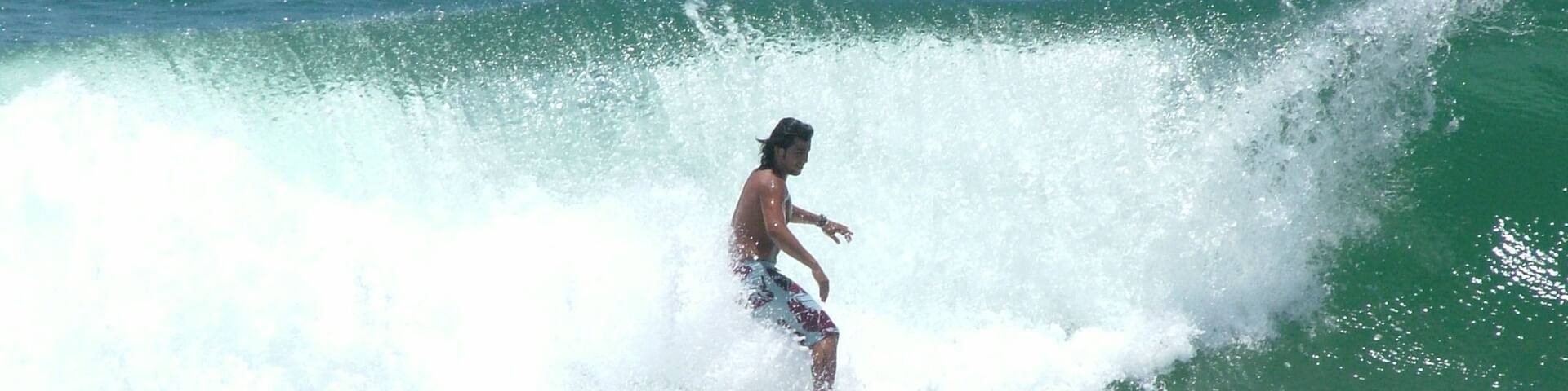 A surfer riding a wave in the ocean.