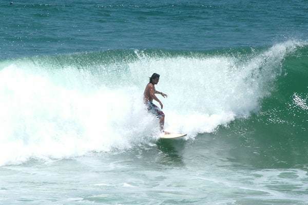 A surfer riding a wave in the ocean.
