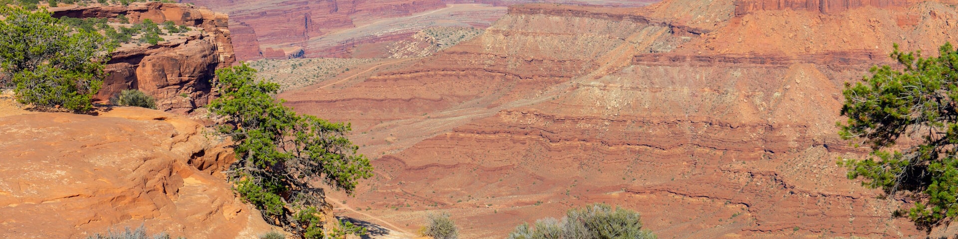 Aerial view of canyon at the Island in the Sky Visitor Center with La Sal Mountains at the background in Canyonlands National Park, Moab, Utah, USA.