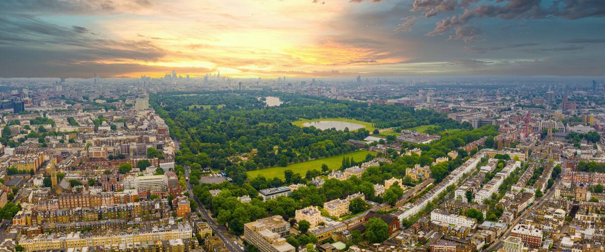 A cityscape with a large park and a stadium.