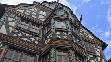 A building with intricate architectural details, including ornate carvings and a coat of arms.