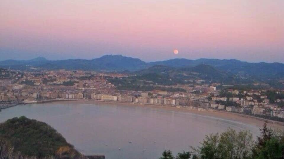 San Sebastián at sunset. Short hike or gondola ride to the top of the viewpoint. There's an awesome old school amusement park at the top of the mountain
