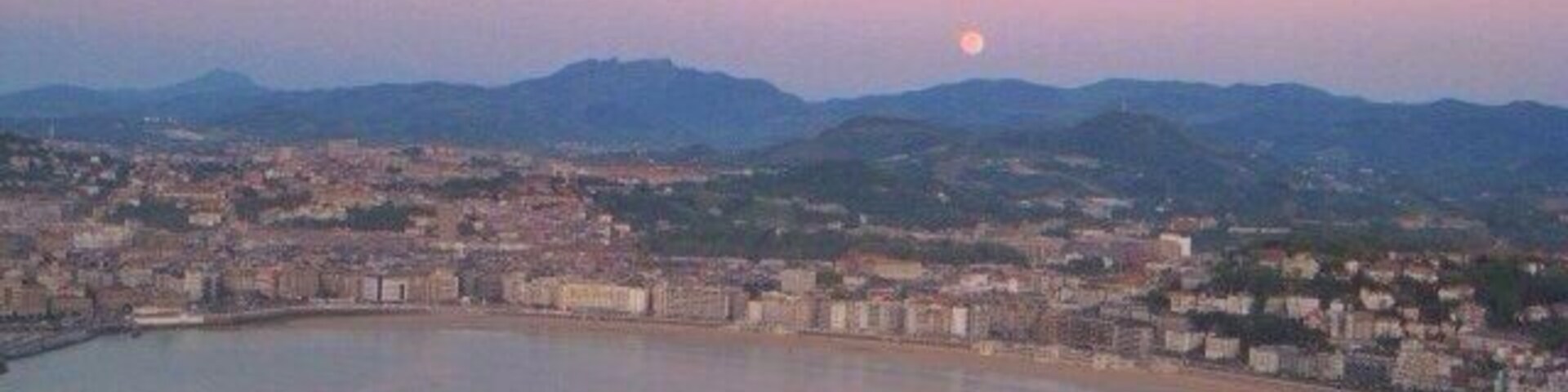San Sebastián at sunset. Short hike or gondola ride to the top of the viewpoint. There's an awesome old school amusement park at the top of the mountain
