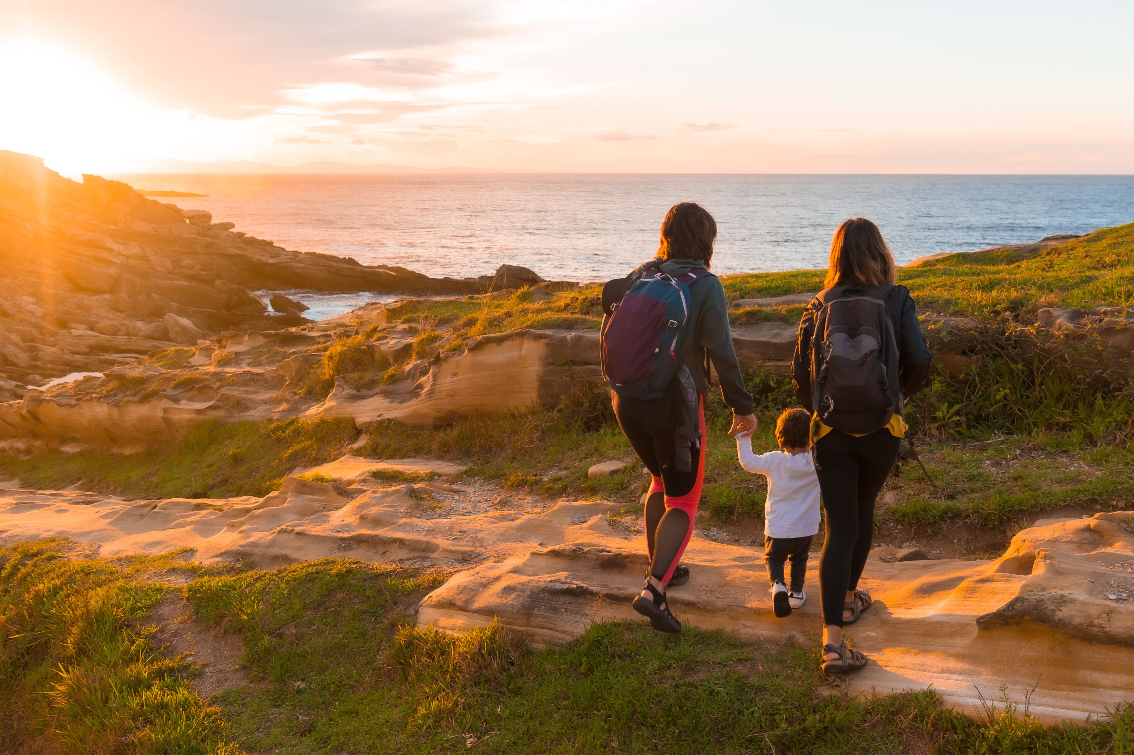 Two women with a child on the coast of Mount Jaizkibel next to San Sebastian, Pais Vasco