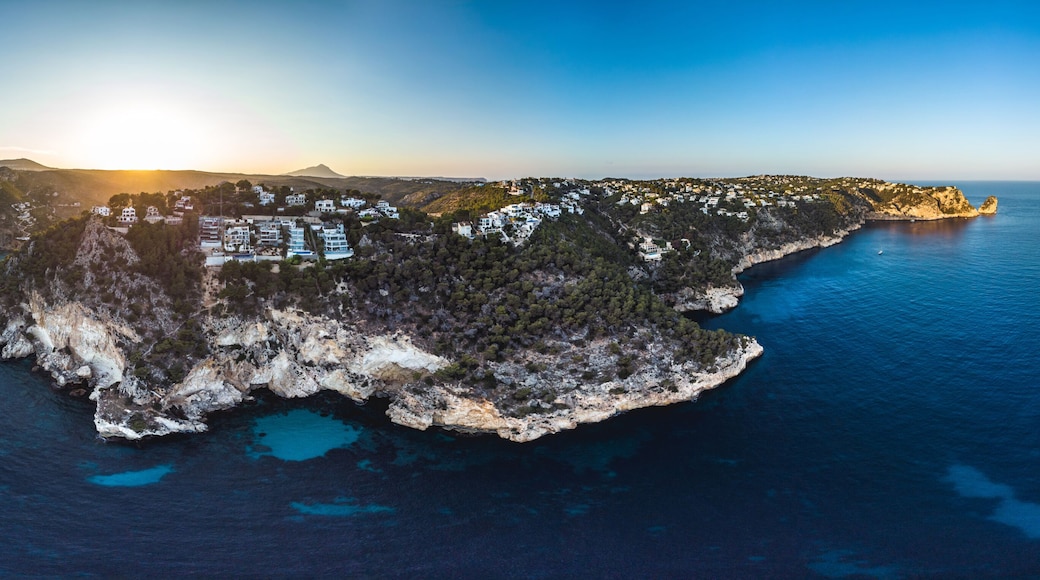 Arial drone view on Granadella beach sheltered between two rocky headlands in the province of Alicante, Valencia, Spain, Xabia, Javea, back side of the Montgo summer 2018. Golden hour sunset and pines