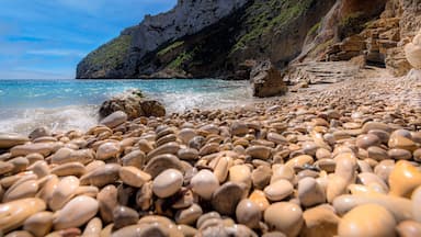 Wet pebbles, Grandella Beach, Javea, Alicante, Spain.