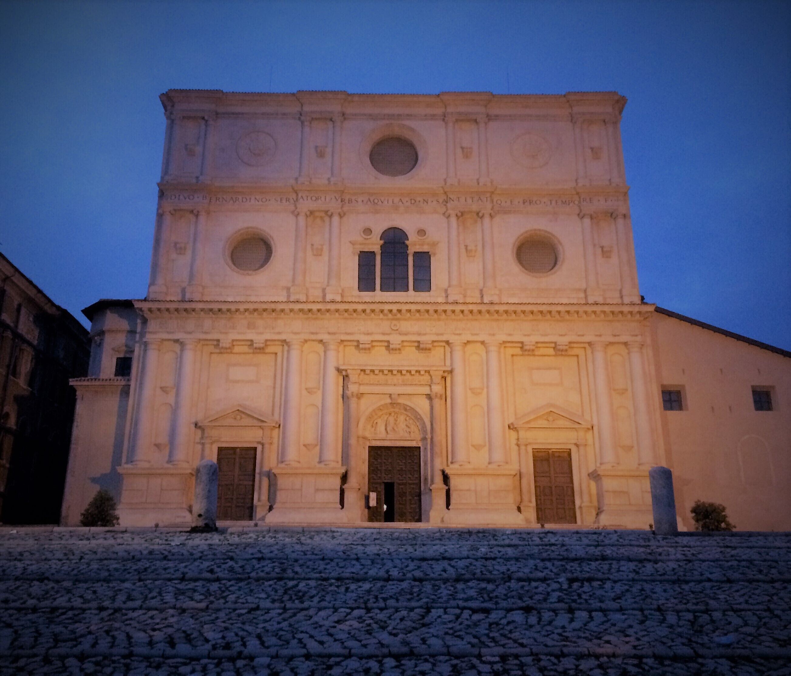 A historic church with a large central dome, arched windows, and a stone facade.
