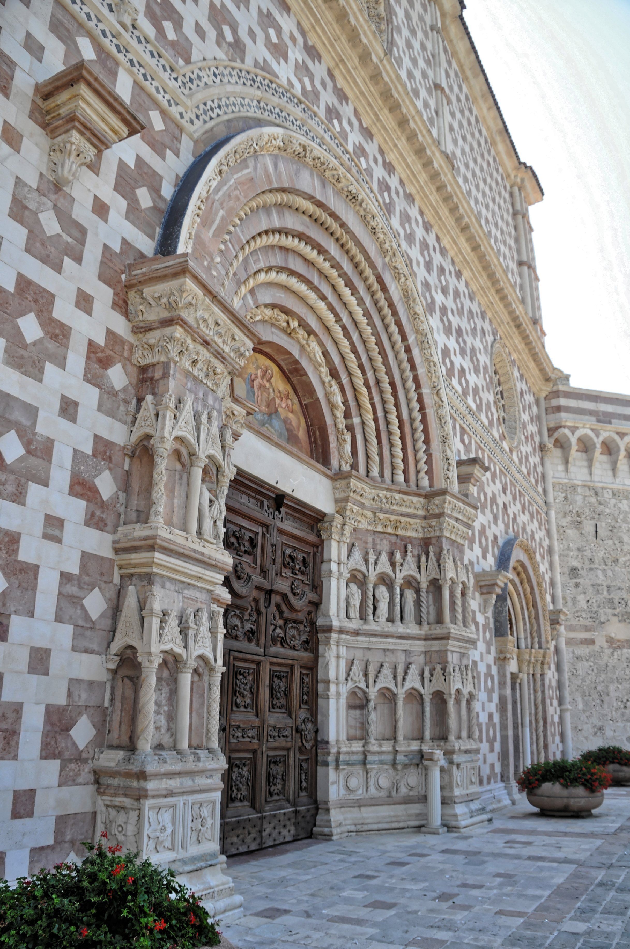 A historic building with intricate stonework and a large ornate door.