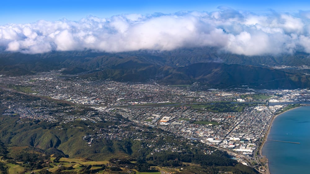 Lower Hutt, Wellington, New Zealand. Panoramic aerial view. Hutt River flows out to sea above Petone Beach at far right. Wainuiomata over the hill at top right.