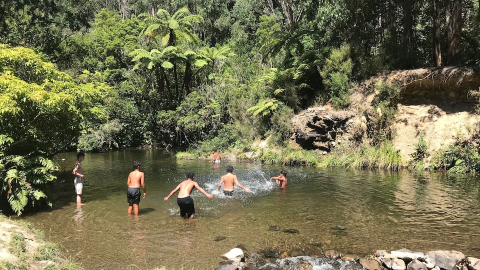 Maori children enjoying a pretty & secluded spot off the main path of Wainuiomata Recreation area, Wellington, New Zealand