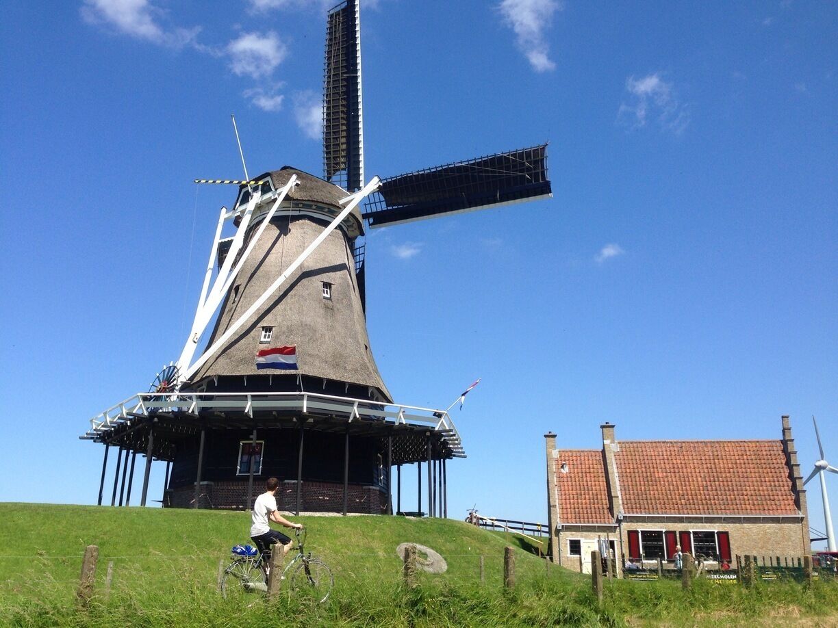 Windmills still are the stereotypical essence of Holland. De Herder (the Shepard) was rebuild in 1989, but there has been a windmill around here since at least 1560. It is in working order (grain) and is now operated by volunteers. 

Do note the cyclist on the bike path. Also in the top 10 of 'what is Holland'.

