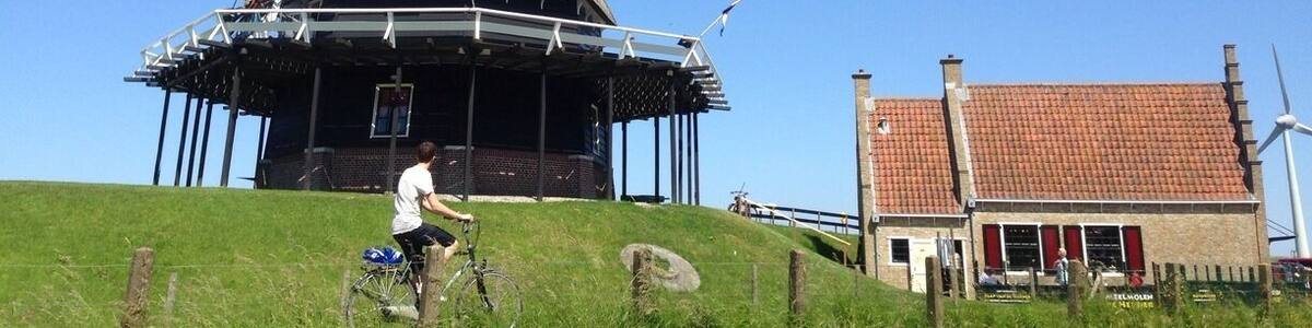 Windmills still are the stereotypical essence of Holland. De Herder (the Shepard) was rebuild in 1989, but there has been a windmill around here since at least 1560. It is in working order (grain) and is now operated by volunteers.
Do note the cyclist on the bike path. Also in the top 10 of 'what is Holland'.