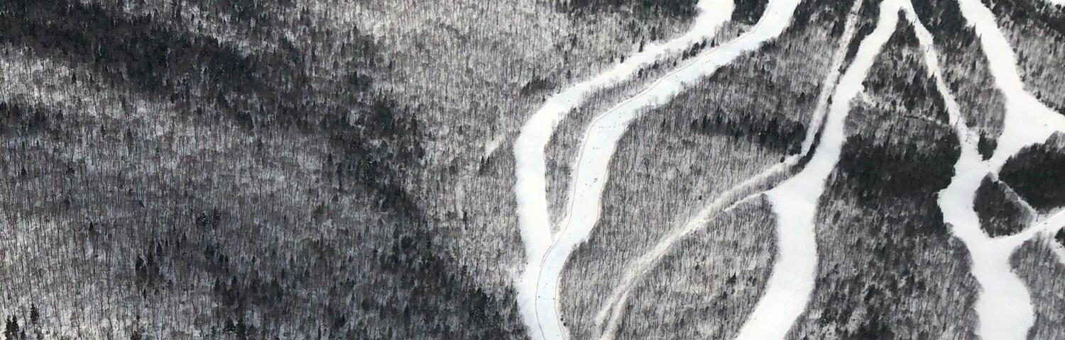 Un paisaje nevado de montañas con carreteras serpenteantes.